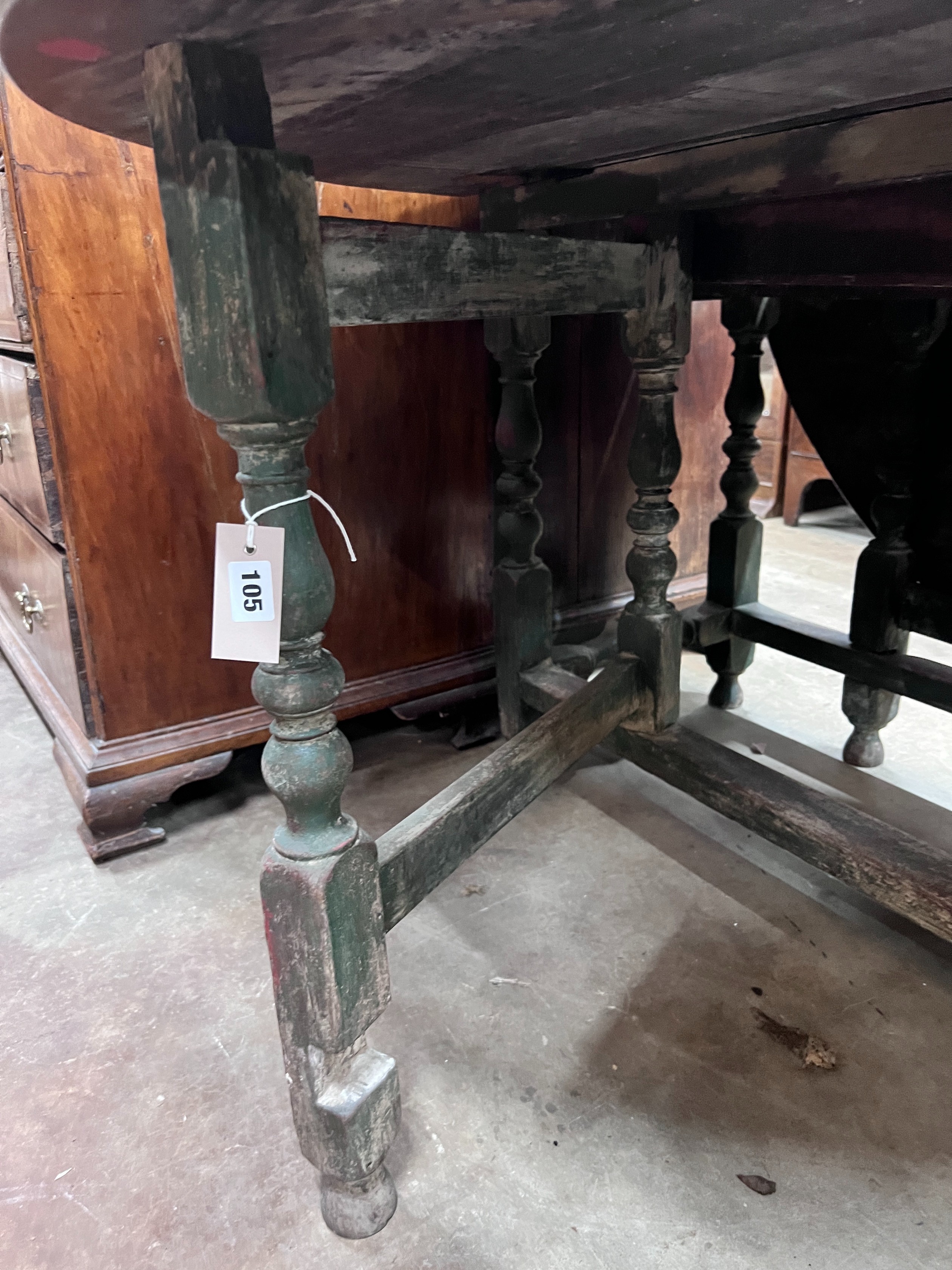 An 18th century oak gateleg dining table, the turned underframe with traces of old paint, length 123cm, depth extended 134cm, height 72cm *Please note the sale commences at 9am.